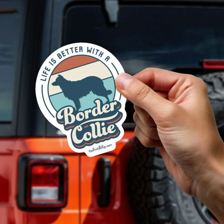 Person-Holding-Sticker_Orange-Jeep-in-Background-Mockup_Retro