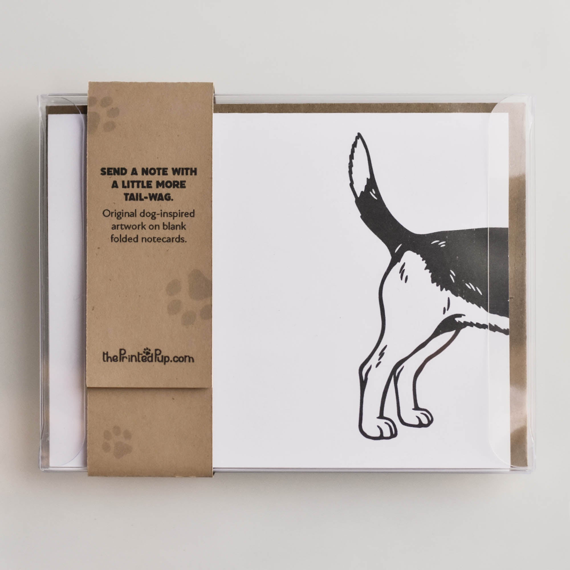 Back view of the Beagle notecard set packaging showing the kraft belly band, blank card back, and continuation of the dog illustration.