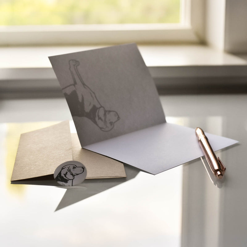 Open Beagle notecard showing the blank interior, with a kraft envelope, matching seal, and pen used as a writing prop for scale.